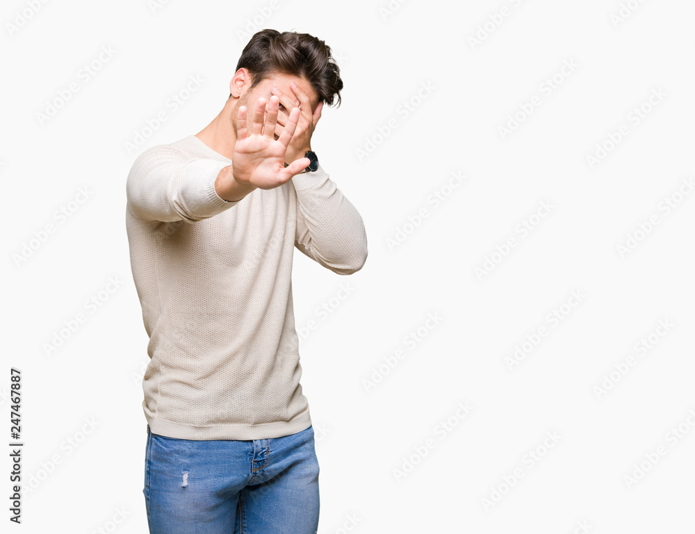 Young handsome man over isolated background covering eyes with hands and doing stop gesture with sad and fear expression. Embarrassed and negative concept. Young handsome man over isolated background covering eyes with hands and doing stop gesture with sad and fear expression. Embarrassed and negative concept.
