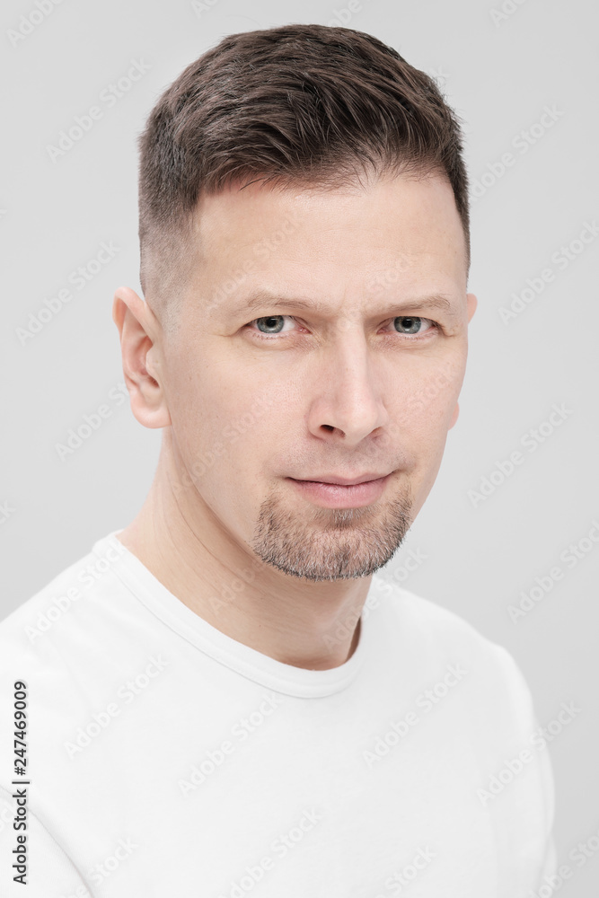 Futuristic handsome bearded brunet man 40s years in white clothes on a white background close-up. God, teacher and boss. Futuristic handsome bearded brunet man 40s years in white clothes on a white background close-up. God, teacher and boss.