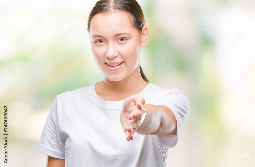 Young beautiful caucasian woman over isolated background smiling friendly offering handshake as greeting and welcoming. Successful business. Young beautiful caucasian woman over isolated background smiling friendly offering handshake as greeting and welcoming. Successful business.