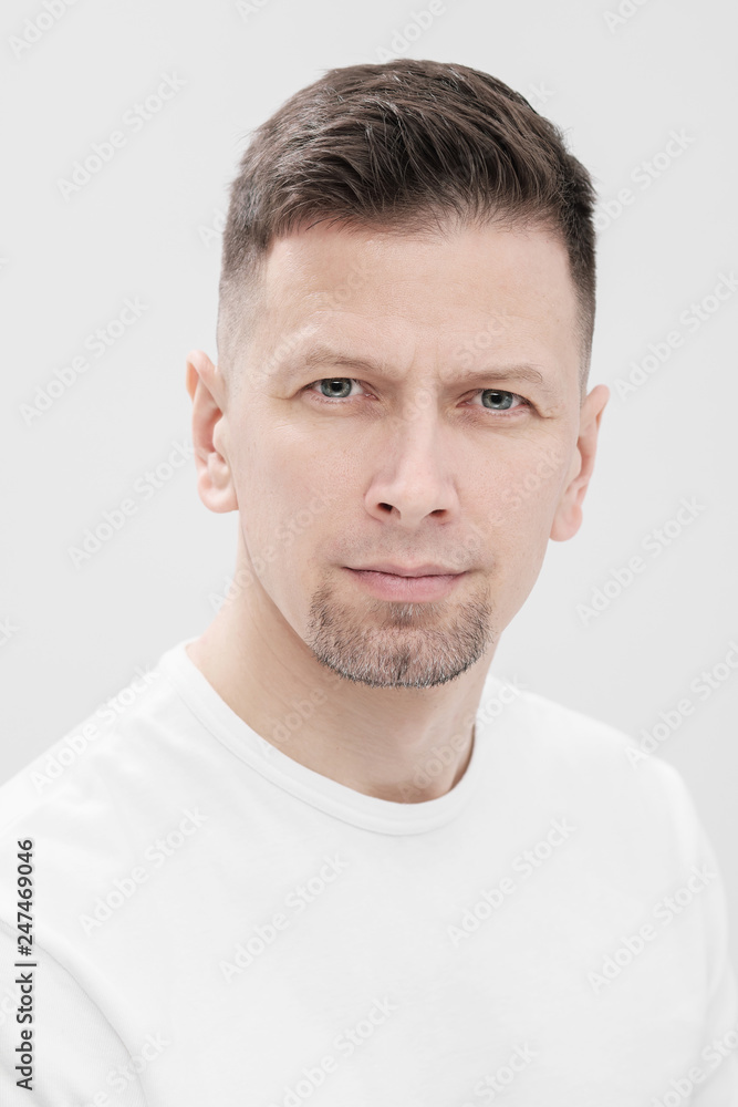 Futuristic handsome bearded brunet man 40s years in white clothes on a white background close-up. God, teacher and boss. Futuristic handsome bearded brunet man 40s years in white clothes on a white background close-up. God, teacher and boss.