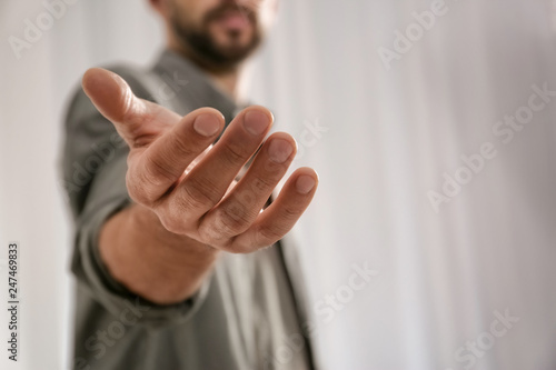 Man giving hand to somebody, closeup with space for text. Help and support concept