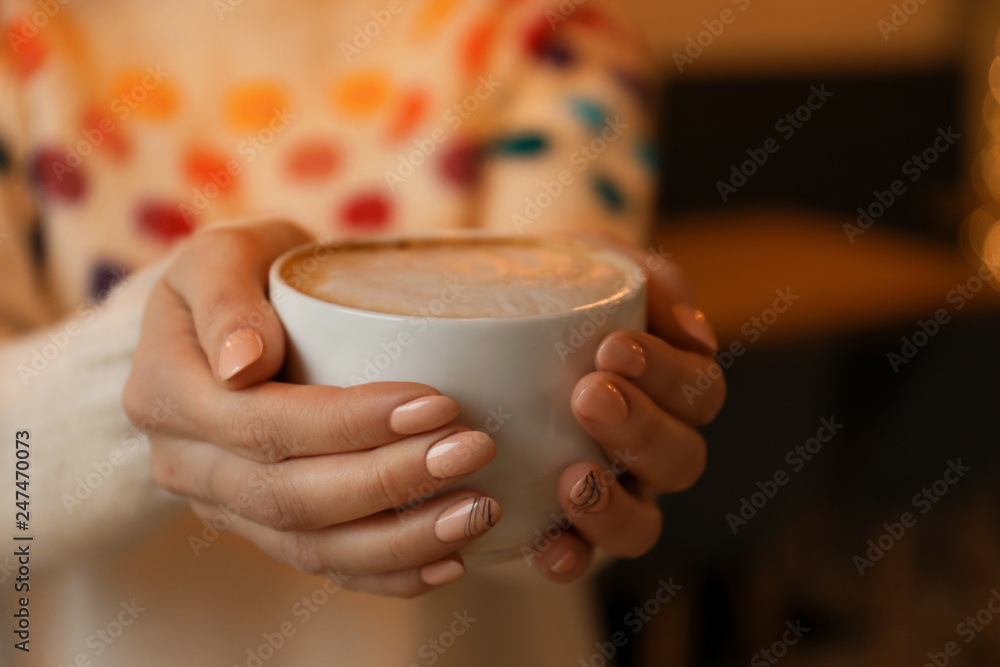 Woman with cup of aromatic cacao on blurred background, closeup Woman with cup of aromatic cacao on blurred background, closeup