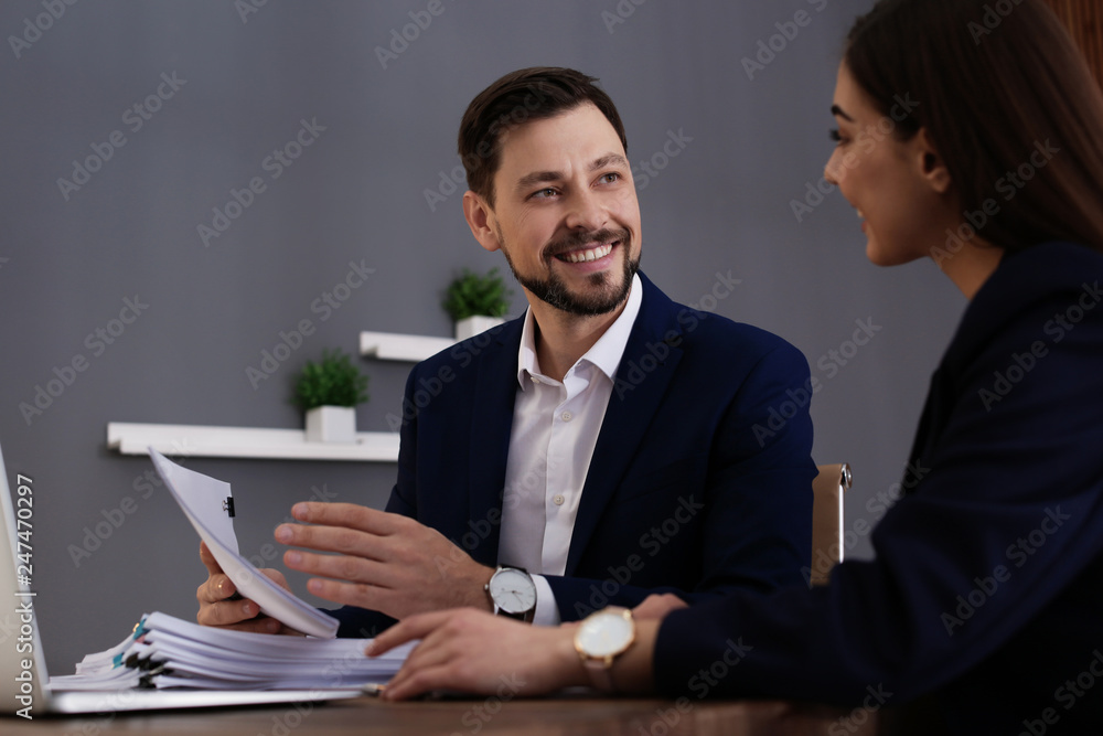 Office employees working with documents at table indoors Office employees working with documents at table indoors