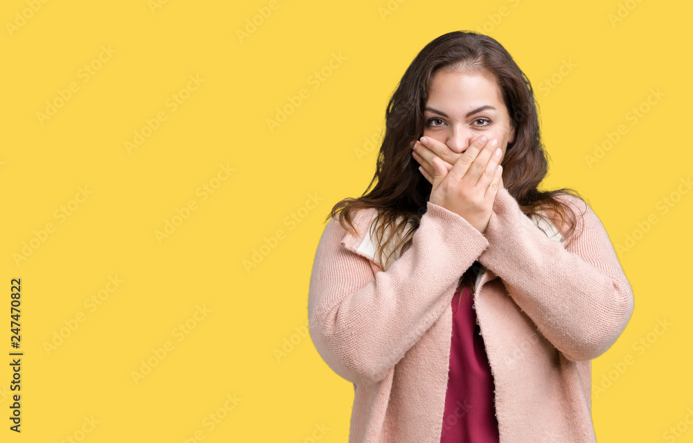 Beautiful plus size young woman wearing winter coat over isolated background shocked covering mouth with hands for mistake. Secret concept. Beautiful plus size young woman wearing winter coat over isolated background shocked covering mouth with hands for mistake. Secret concept.