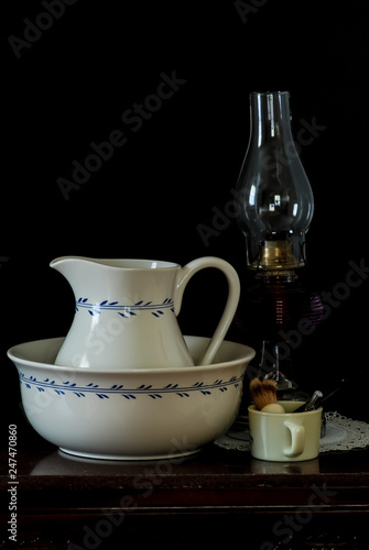 Antique wash basin and pitcher on marble-top wash stand with Kerosene lamp and soap dish