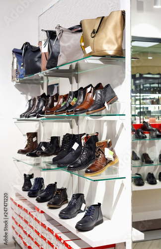 Shelves with beautiful leather shoes and bags in store
