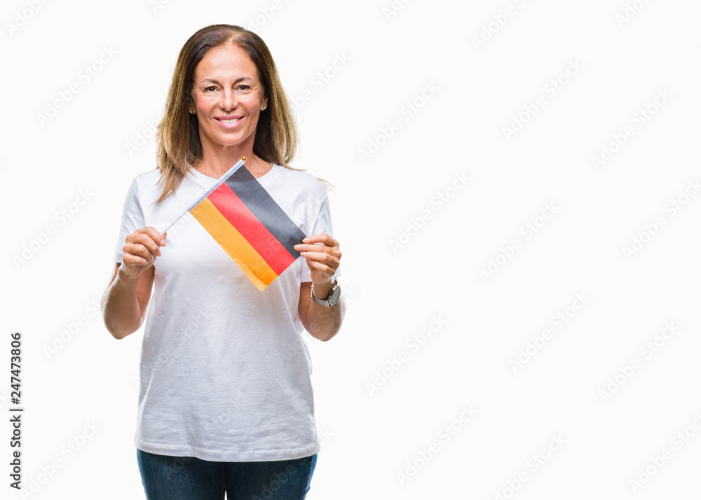 Middle age hispanic woman holding flag of Germany over isolated background with a happy face standing and smiling with a confident smile showing teeth Middle age hispanic woman holding flag of Germany over isolated background with a happy face standing and smiling with a confident smile showing teeth