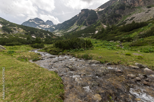 Landscape with dark clouds over Malyovitsa peak and Malyoviska river  Rila Mountain  Bulgaria