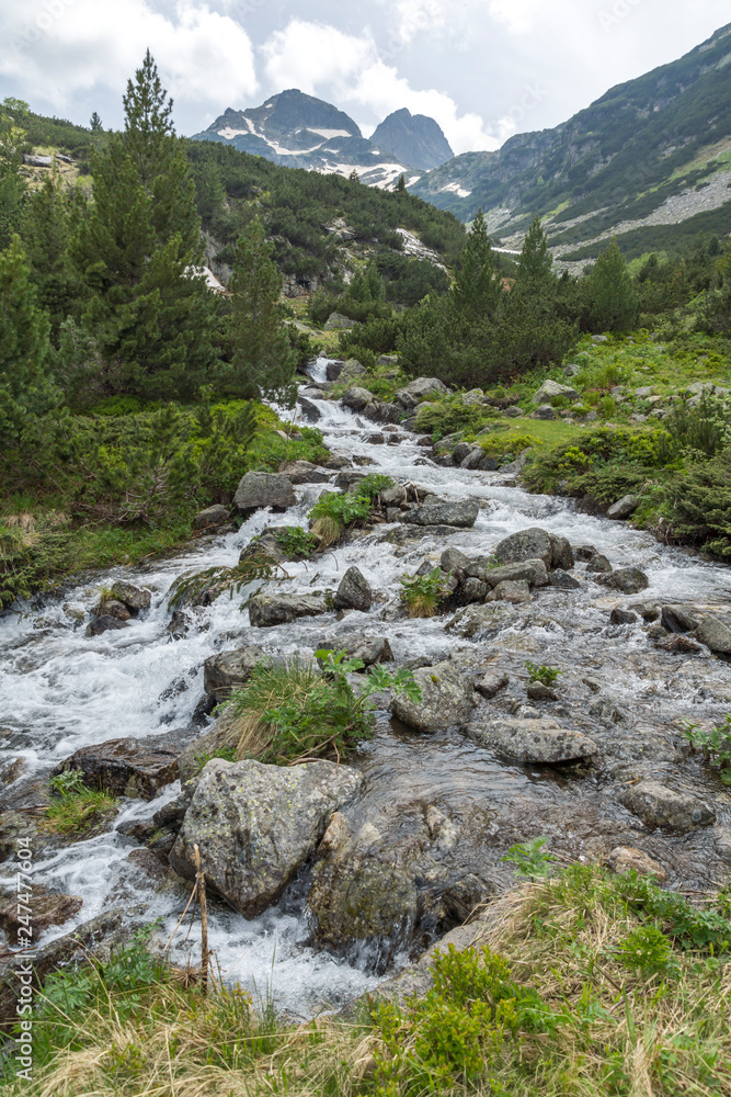Landscape with dark clouds over Malyovitsa peak and Malyoviska river, Rila Mountain, Bulgaria Landscape with dark clouds over Malyovitsa peak and Malyoviska river, Rila Mountain, Bulgaria