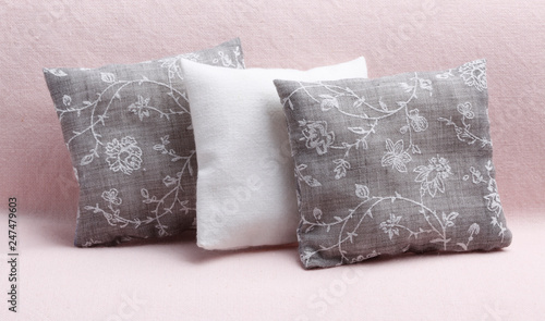 Three pillows with floral ornament