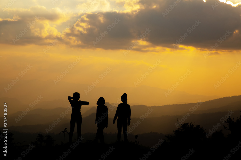 Silhouette, group of happy girl playing on hill, sunset, summertime Silhouette, group of happy girl playing on hill, sunset, summertime