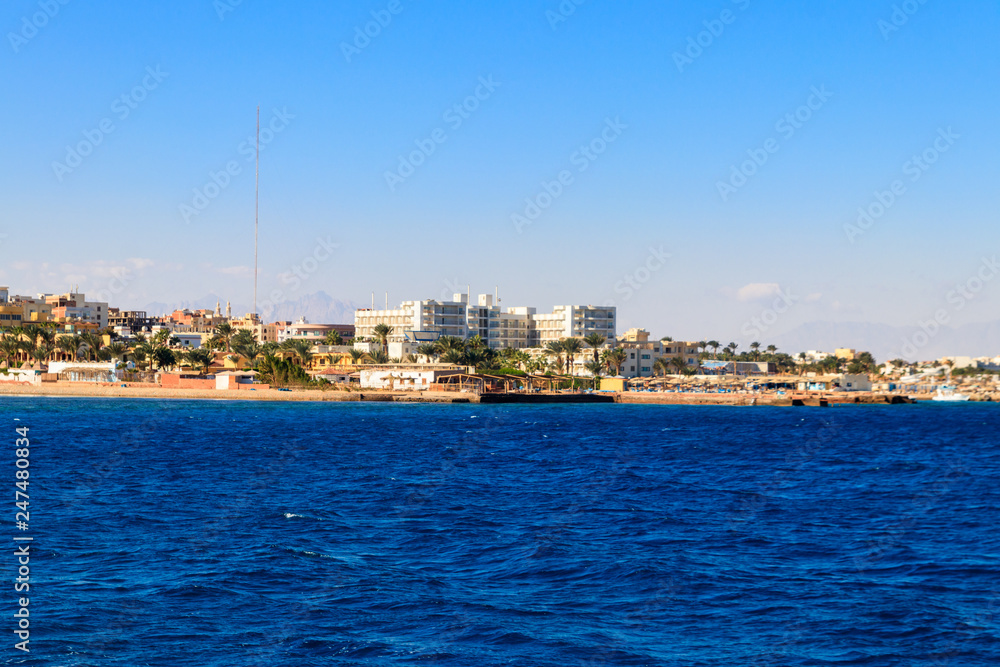 Beautiful view of the coastline with houses and hotels in Hurghada, Egypt. View from Red sea