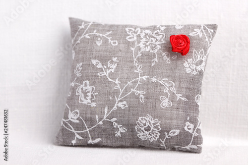 Red rose on the gray cushion