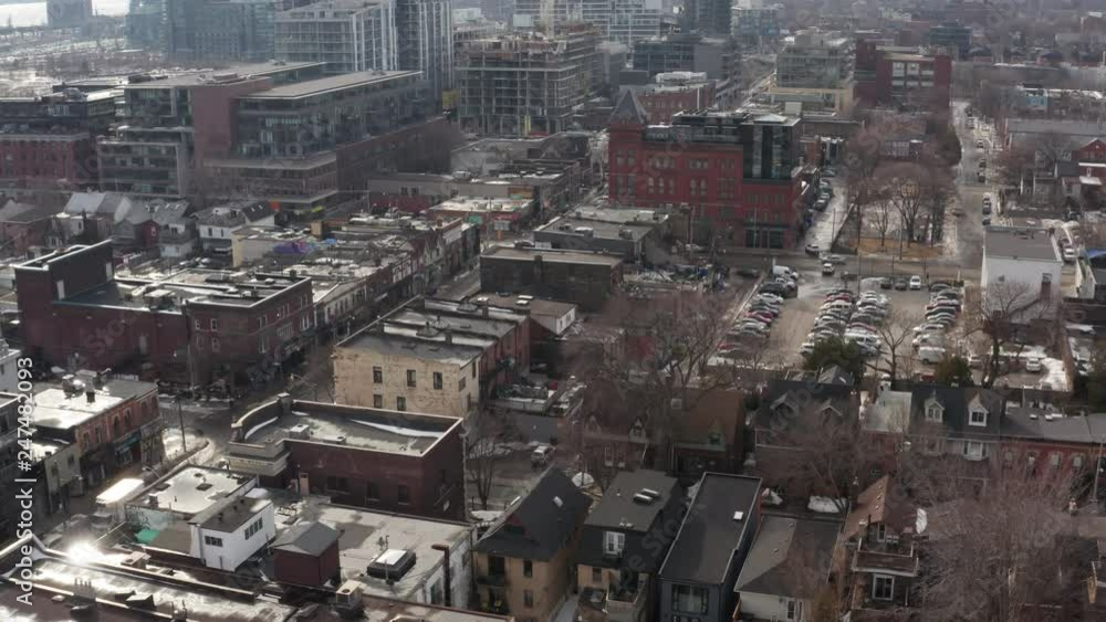 Aerial of busy urban intersection with mix residential and commerical buildings during winter Aerial of busy urban intersection with mix residential and commerical buildings during winter
