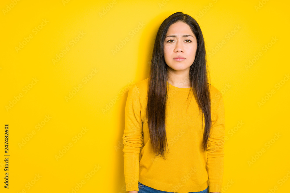 Beautiful brunette woman over yellow isolated background depressed and worry for distress, crying angry and afraid. Sad expression. Beautiful brunette woman over yellow isolated background depressed and worry for distress, crying angry and afraid. Sad expression.