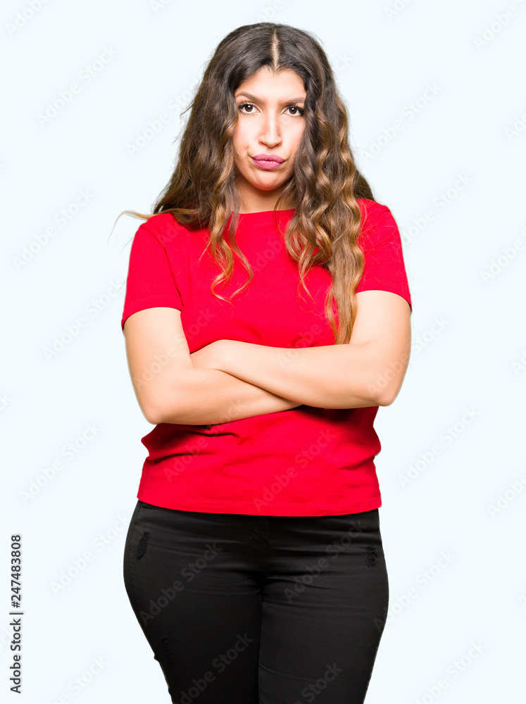 Young beautiful woman wearing casual t-shirt skeptic and nervous, disapproving expression on face with crossed arms. Negative person. Young beautiful woman wearing casual t-shirt skeptic and nervous, disapproving expression on face with crossed arms. Negative person.