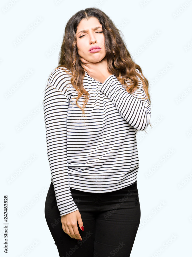 Young beautiful woman wearing stripes sweater Touching painful neck, sore throat for flu, clod and infection Young beautiful woman wearing stripes sweater Touching painful neck, sore throat for flu, clod and infection