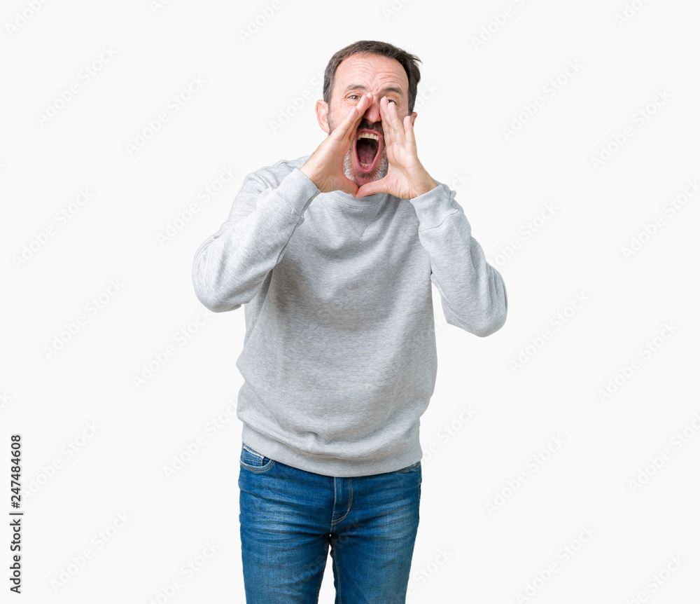 Handsome middle age senior man wearing a sweatshirt over isolated background Shouting angry out loud with hands over mouth Handsome middle age senior man wearing a sweatshirt over isolated background Shouting angry out loud with hands over mouth
