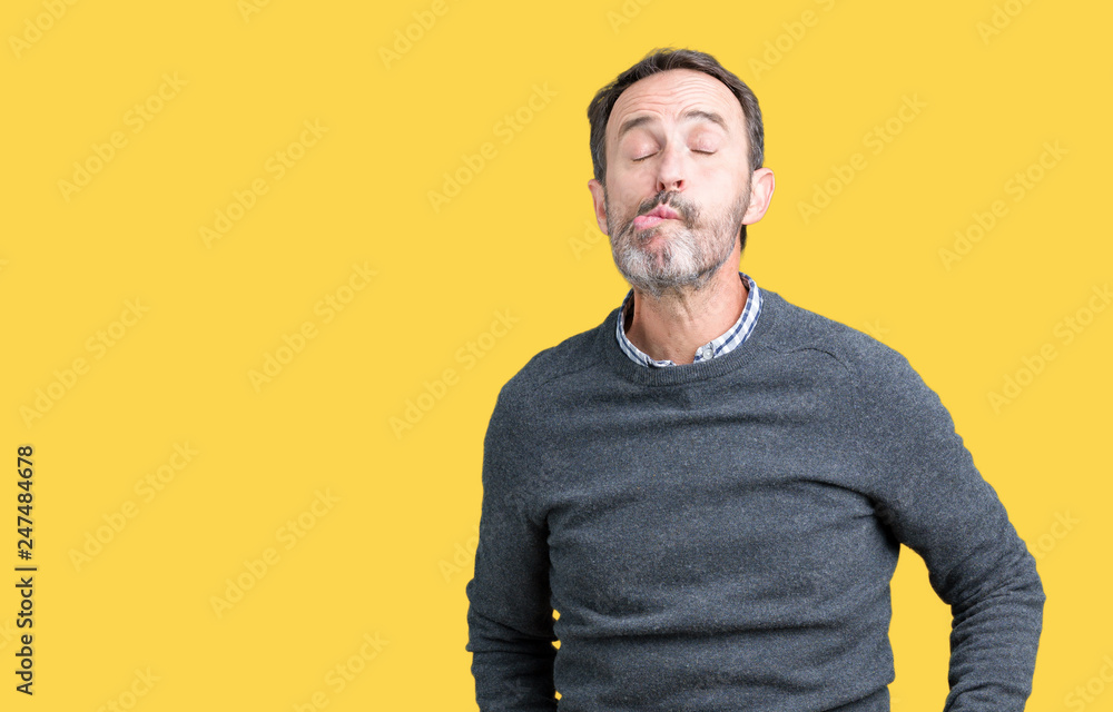 Handsome middle age senior man wearing a sweater over isolated background making fish face with lips, crazy and comical gesture. Funny expression. Handsome middle age senior man wearing a sweater over isolated background making fish face with lips, crazy and comical gesture. Funny expression.