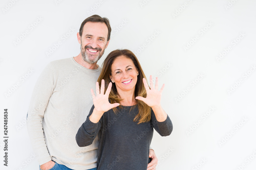 Beautiful middle age couple in love over isolated background showing and pointing up with fingers number ten while smiling confident and happy. Beautiful middle age couple in love over isolated background showing and pointing up with fingers number ten while smiling confident and happy.