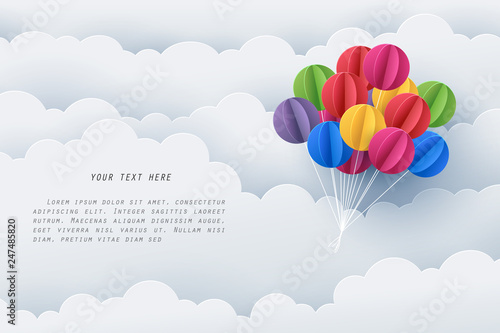 Paper art of colorful balloon fly along a white cloud with copy space for text