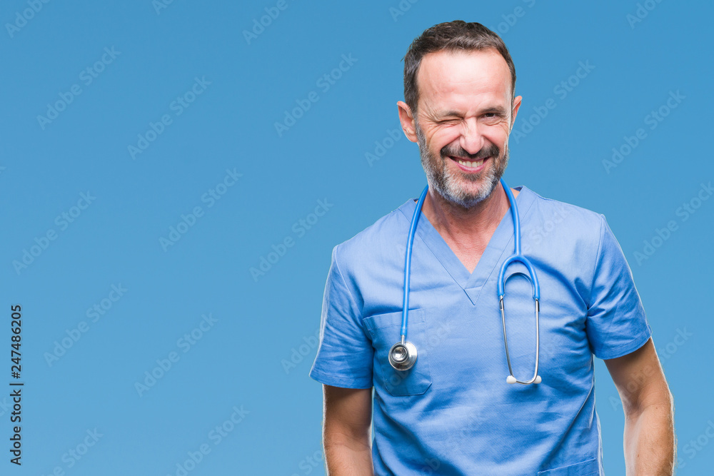 Middle age hoary senior doctor man wearing medical uniform over isolated background winking looking at the camera with sexy expression, cheerful and happy face. Middle age hoary senior doctor man wearing medical uniform over isolated background winking looking at the camera with sexy expression, cheerful and happy face.