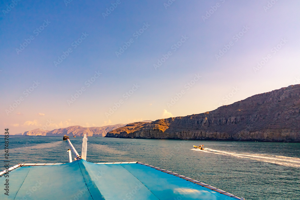 Fototapeta premium Sea, pleasure boats, rocky shores in the fjords of the Gulf of Oman