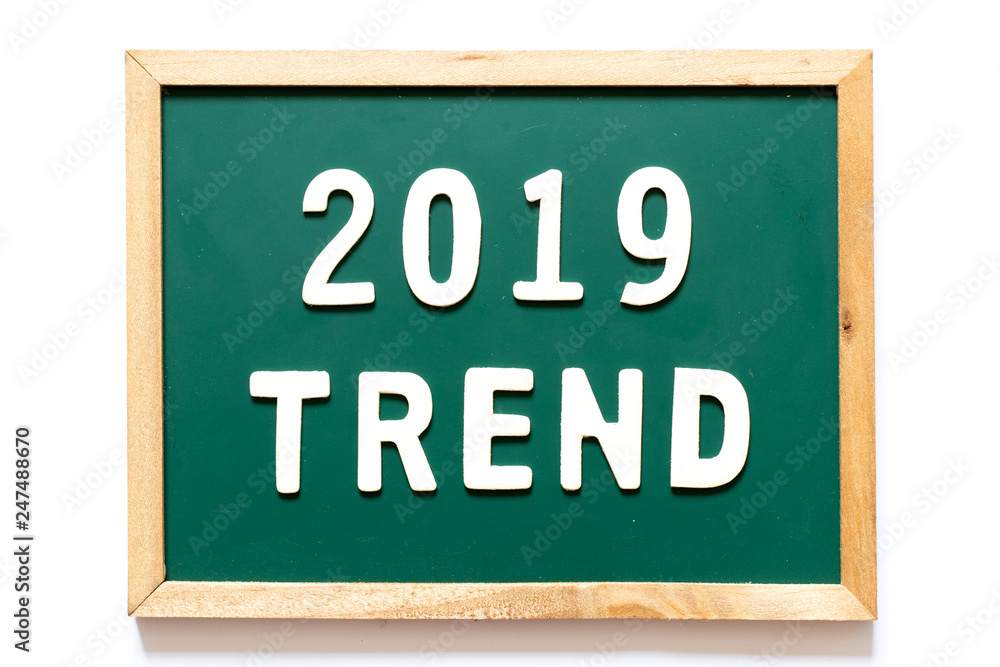 Green blackboard and wood frame with word 2019 trend on white background