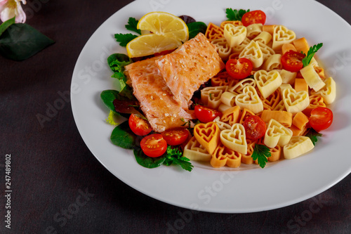 Plate in the form of a heart pasta with salmon and lemon