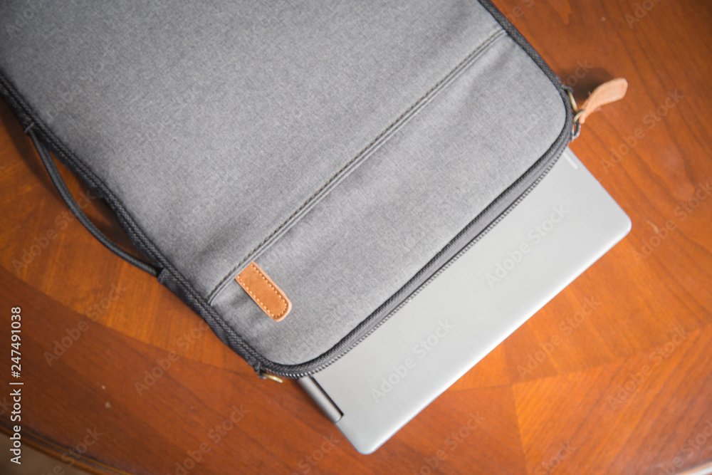 laptop sitting on wooden table with case and glasses. good for a writer, editor, author or entrepreneur. laptop sitting on wooden table with case and glasses. good for a writer, editor, author or entrepreneur.