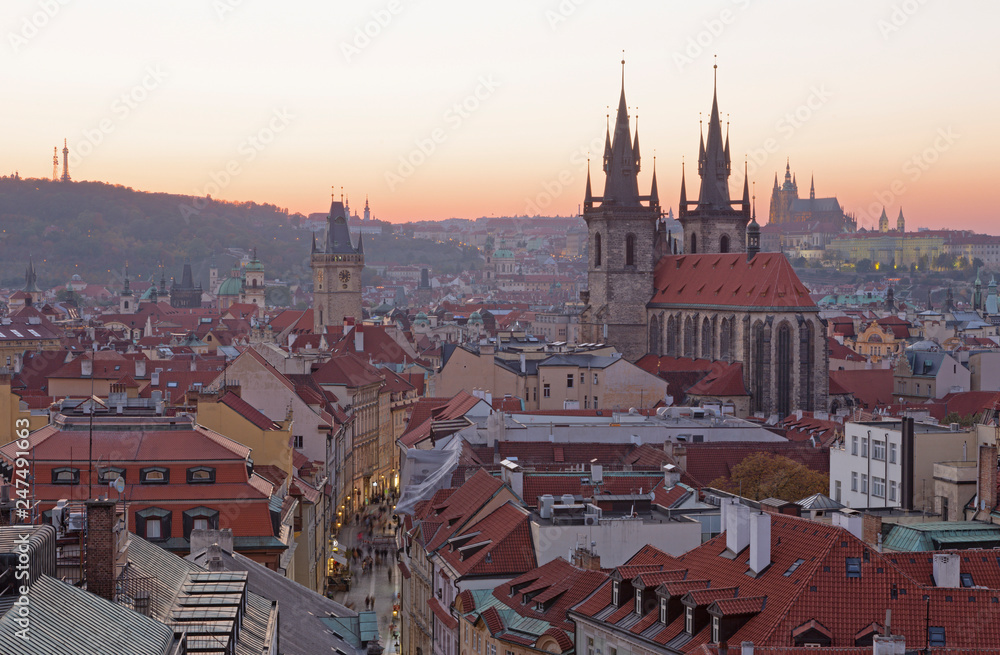 Prague - The City with the Church of Our Lady before Týn and Castle with the Cathedral in the background at dusk.