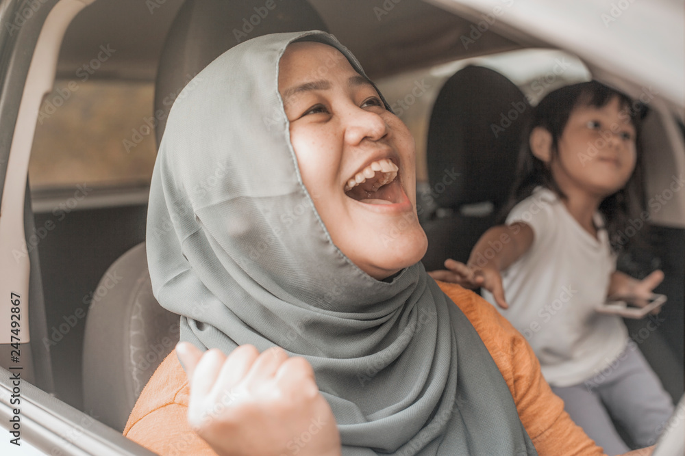 Fototapeta premium Muslim Lady Dancing Happily in Her Car