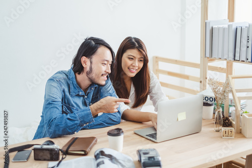Young Asian man and woman working at home with internet laptop for online business concept