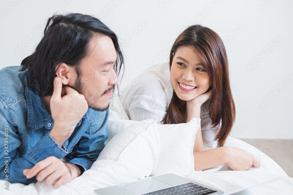 Asian couple lover relaxing on white bed, lifestyle Asian couple Valentine concept Asian couple lover relaxing on white bed, lifestyle Asian couple Valentine concept