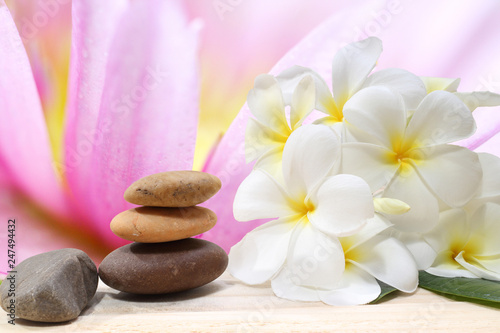 Zen spa concept background - Zen massage stones with frangipani plumeria flower