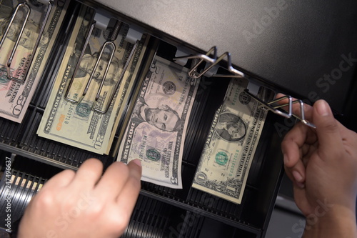 High angle view of cashier searching for change in cash