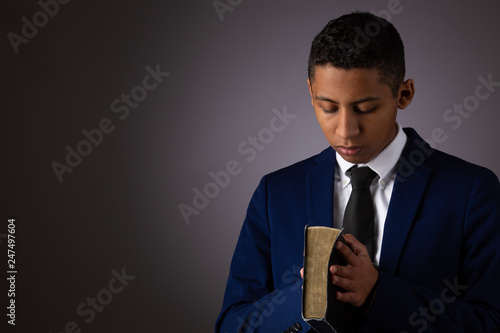 Canvas Print Hispanic Teenager Boy Seeking to Commune with God Via Prayer and Holding the Holy Bible