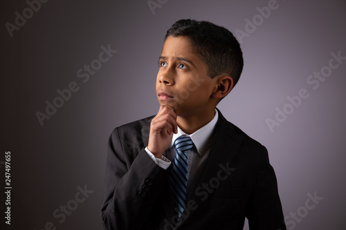 Hispanic Little Boy Deeply Meditating on Complex Subject