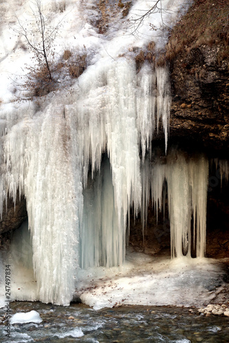 Photo of white frozen waterfalls in the mountains in the valley photo