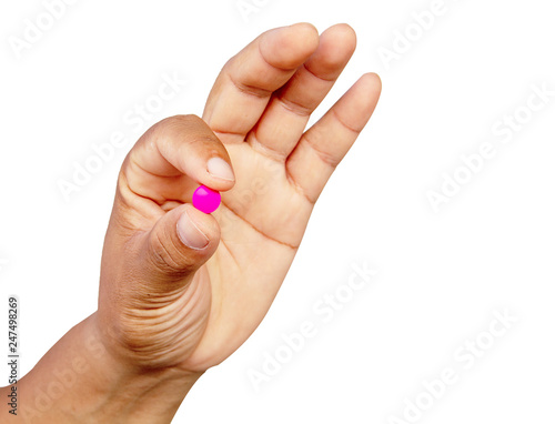 Man's hand holding pink drug, isolate on white background with clipping path.