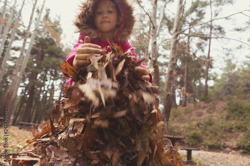 Konstfotografi Happy Child Playing in the Leaves at Autumn Time