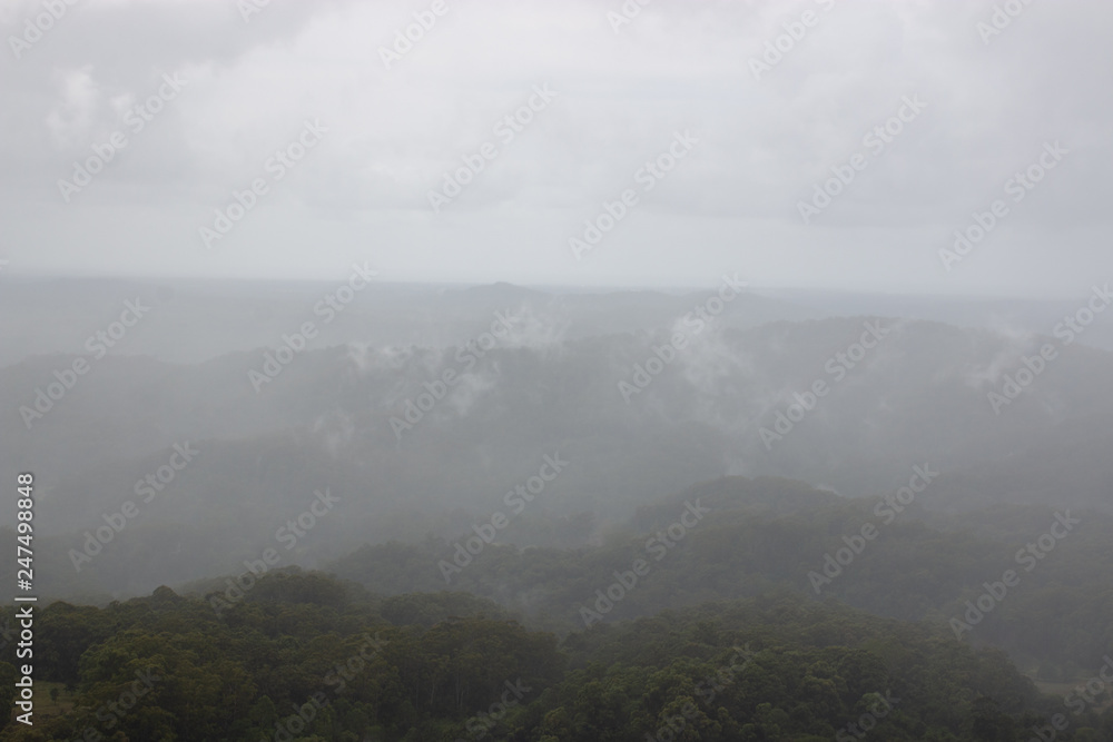 morning in the mountains with rain , mist and fog