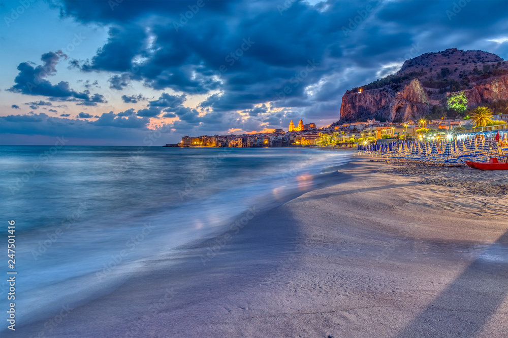 The beach of Cefalu at the north coast of Sicily before sunrise