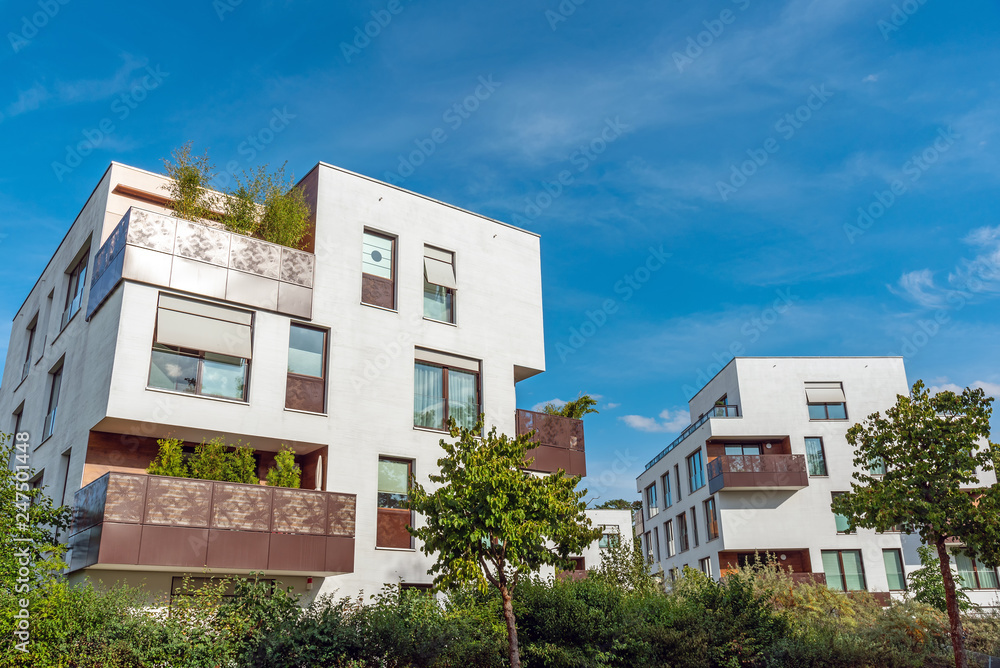 Modern white apartment houses with a blue sky seen in Berlin, Germany Modern white apartment houses with a blue sky seen in Berlin, Germany