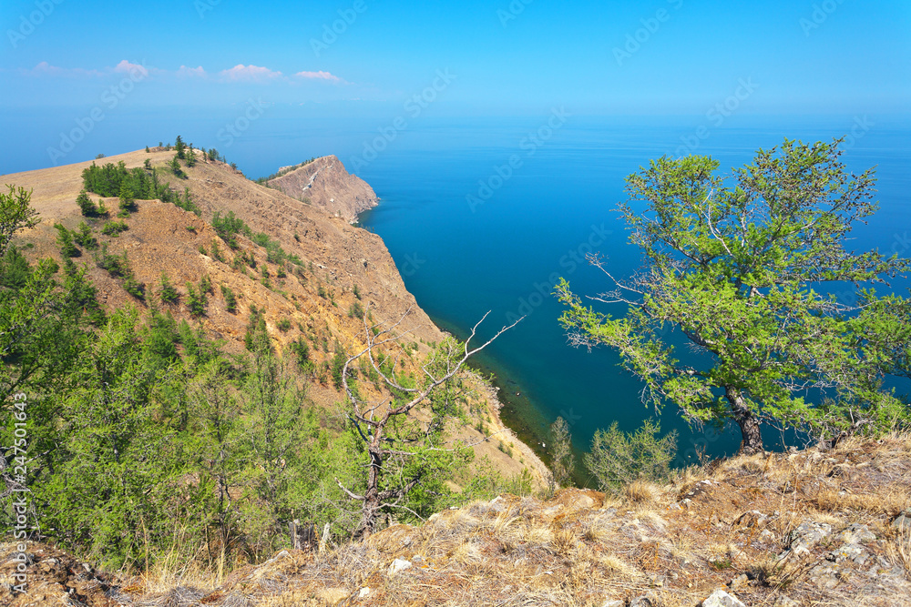 Baikal Lake in June. The northern edge of the Olkhon island and the famous Cape Khoboy - a natural landmark. Trips, excursions and hikes around the island in summer