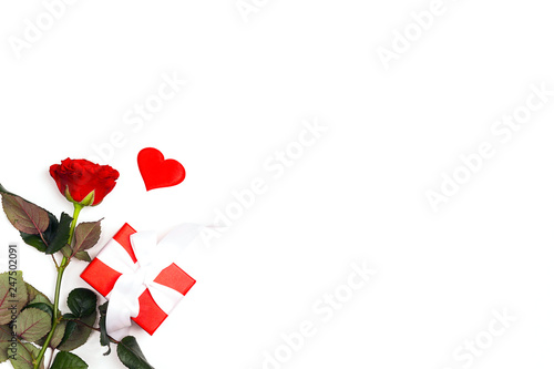 Gift box, rose flower and decorative hearts on white background. Place for text, top down composition.