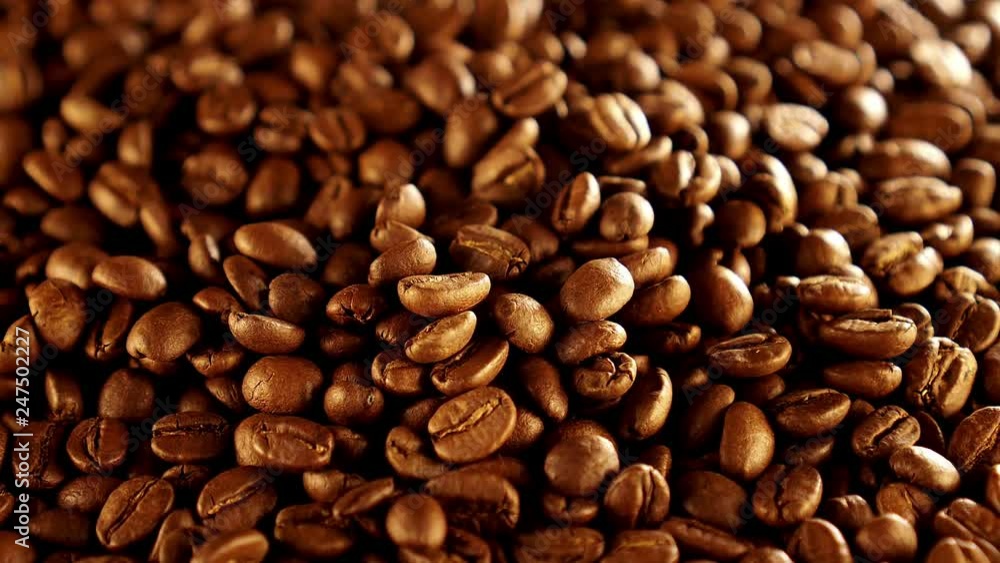 Coffee beans rotation in the slowed-down movement macro. Coffee beans rotation in the slowed-down movement macro.