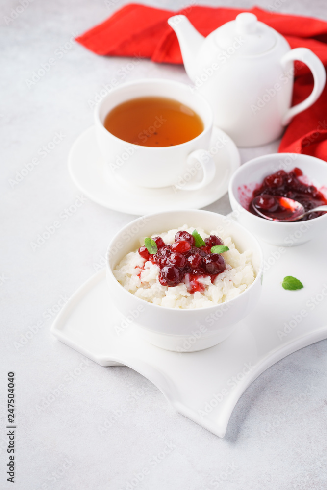Rice porridge with cranberries, jam and tea for breakfast. Rice porridge with cranberries, jam and tea for breakfast.