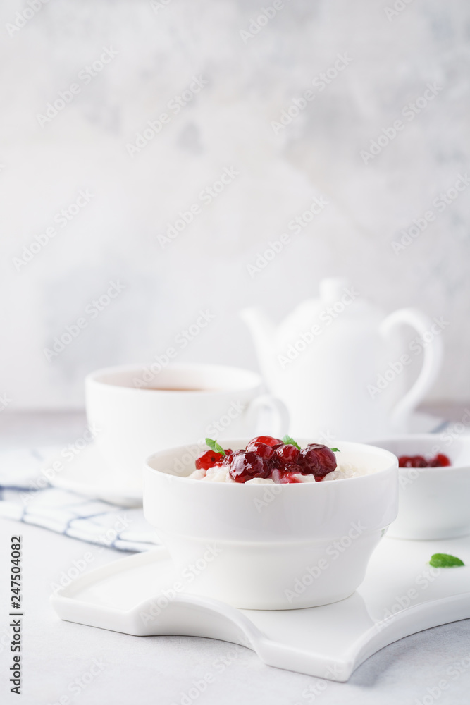 Bowl of rice porridge with cranberries and jam for breakfast. Bowl of rice porridge with cranberries and jam for breakfast.