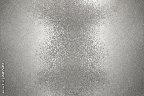 Reflection on rough silver wall surfaces, abstract background